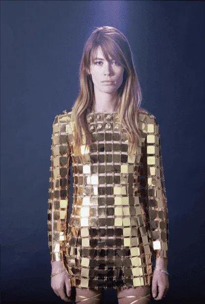 Model wearing a metallic gold chainmail-style dress by Paco Rabanne