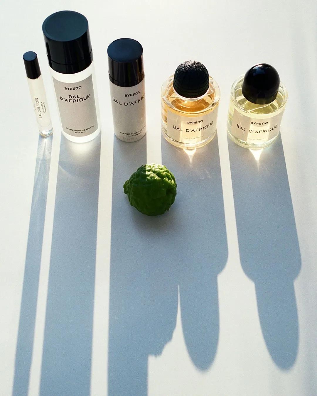 Byredo "Bal d'Afrique" fragrance range with bottles, candle and a green pod